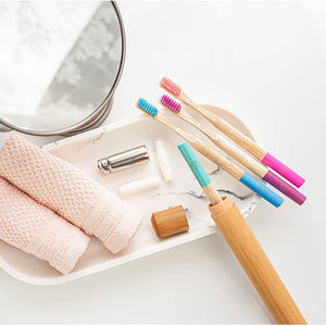 Set of bamboo toothbrushes, vegan floss, and travel case.